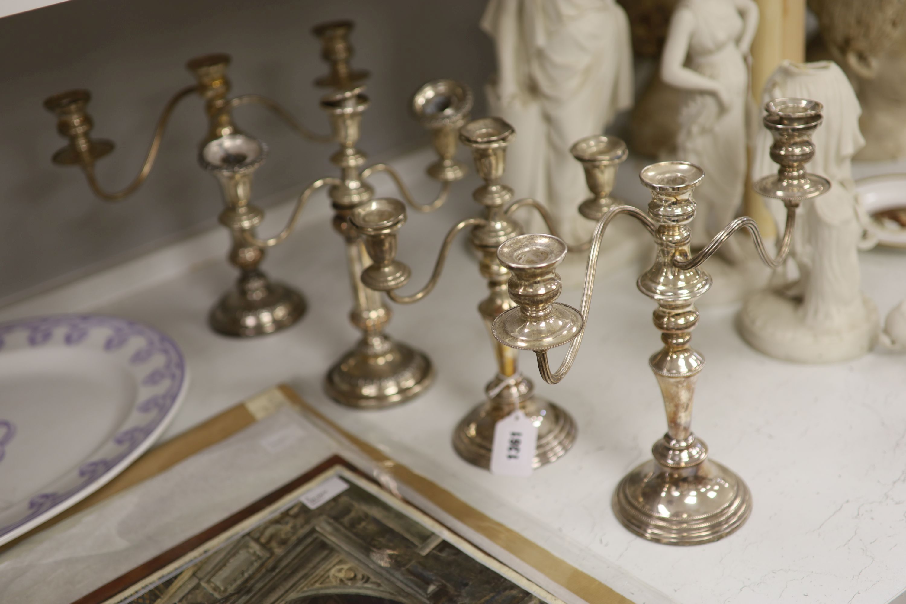 Two pairs of silver plated two branch candelabra, height 30cm